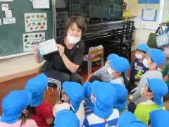 写真：先生の説明を聞く、子どもたち